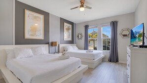 A modern bedroom with two beds, a ceiling fan, and a large window with curtains. - Last Minute Disney! Private Pool, Hot Tub, Game Room & Themed Bedrooms. Book Now! #56653 (Orlando)