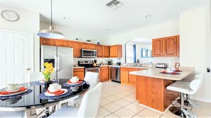 Enjoy cooking in the well-equipped kitchen with a central island, sink, and appliances.