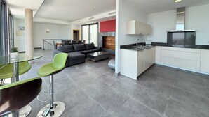 A modern apartment with a living area, dining space, and kitchen. - Agi Canyelles Mar Casa 1 Casa for rent in Roses Girona. (Roses)