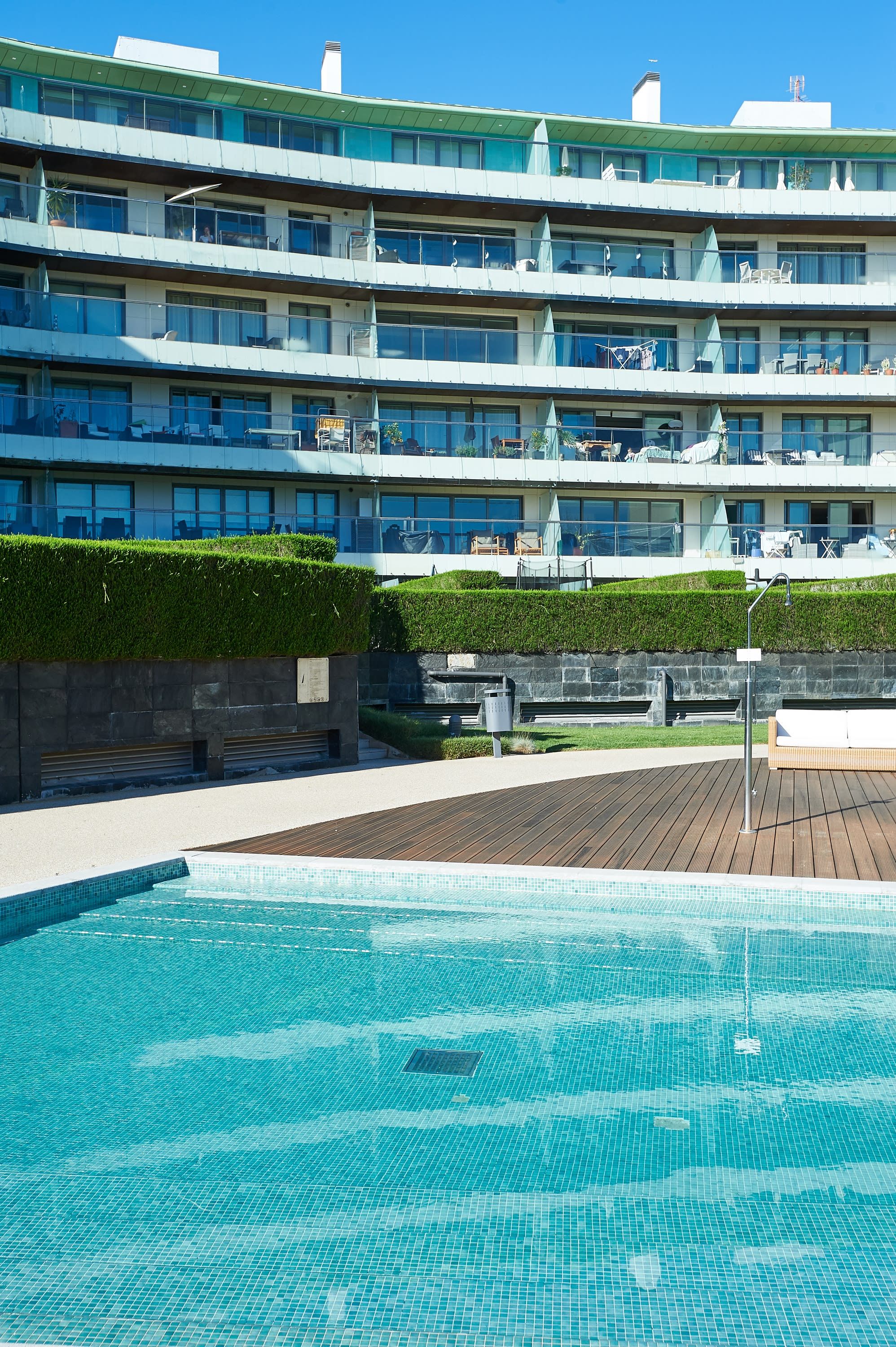 A multi-story hotel with a rooftop pool area.