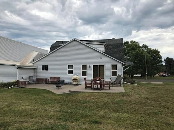 Enjoy a peaceful retreat on the covered patio with comfortable outdoor seating and a scenic view.