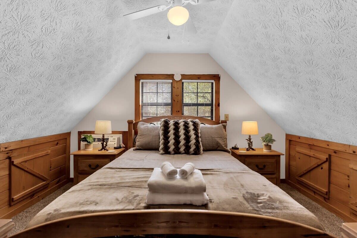 Master bedroom in loft area with queen bed.