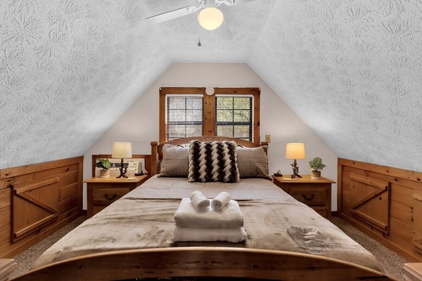 Master bedroom in loft area with queen bed.