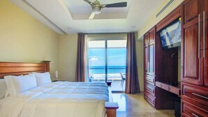 A hotel room with a bed, a ceiling fan, a TV, and a view of the ocean. - 7th Floor Direct Ocean View Penthouse -Parties OK. (Jacó)