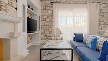 Family Suite | Living area | 72-inch TV with digital channels