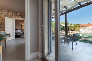 A room with a view of a pool and outdoor seating. - Nefes Hotel Alacati (Cesme)