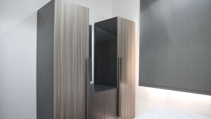 A modern wardrobe with a minimalist design, featuring a combination of wood and metal finishes. - BHomed (Salmiya)