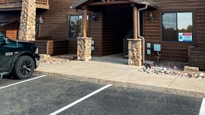 A two-story building with a wooden facade, a stone pillar, and a 'For Sale' sign. - Gorgeous 2BR/2BA with Stunning Views and Great Location (Show Low)