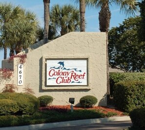 A sign for Colony Reef Club with a number '4670' on a building.