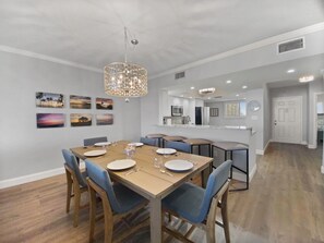 Dining area with table set for six and pendant chandelier