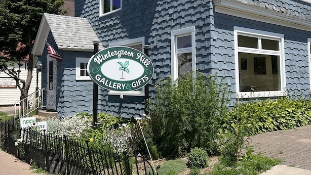 A two-story building with a sign for 'Wimbergreen Hill Gallery & Gifts'.