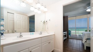 A bathroom with a large mirror, two sinks, and a ceiling fan. - Million-Dollar Gulf Views • Majestic Beach Resort 504 Tower 1• Beachfront • Pool (Panama City Beach)