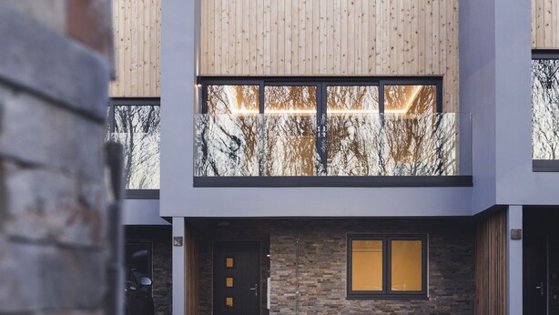 A modern multi-story building with a wooden facade, large windows, and a stone base. - Oceanwalk - sleeps 8 guests  in 4 bedrooms (Perranporth)
