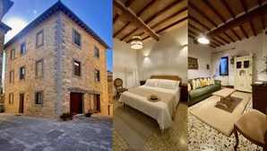 A stone building with a courtyard, a bedroom with a bed and nightstand, and a living room with a sofa and coffee table.