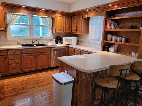 Enjoy cooking and dining in this well-equipped kitchen with a central island, microwave, and coffee maker.