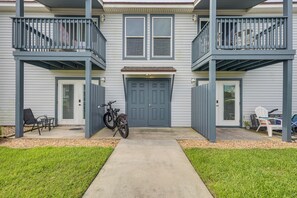 A two-story house with a front porch, a bicycle, and outdoor seating. - < Half-Mi to Fort Clinch Beach! Condo w/ Balcony (Fernandina Beach)