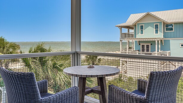 A balcony with wicker furniture and a view of the ocean. - Luxe Beachfront WindMark Cottage w/ Deck! (Port St. Joe)