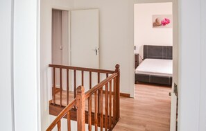 A bedroom with a bed, a nightstand, and a wall-mounted picture. - Awesome home in Coutras with WiFi (Coutras)