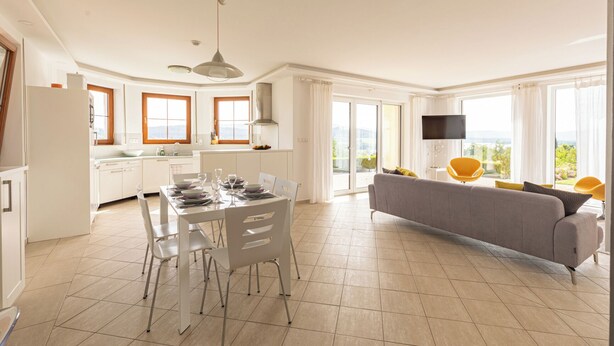 A modern apartment with a dining area, kitchen, and living room with a sofa and chairs. - Villa-view, Pool, Bbq, Playground & Fire pit (Horni Plana)