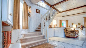 A staircase leading to a landing with a sofa and a lamp. - 3 bedroom amazing home in Sterlawki Male (Sterlawki Male)