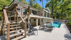 A two-story house with a pool, outdoor seating, and a wooden staircase. - 7 Bald Eagle-3 Row Ocean (75 yards) to the Beach &  40 ft x 10 ft Pool (Hilton Head Island)