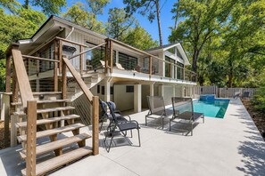 A two-story house with a pool, outdoor seating, and a wooden staircase. - 7 Bald Eagle-3 Row Ocean (75 yards) to the Beach &  40 ft x 10 ft Pool (Hilton Head Island)