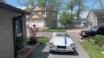 Guests can park their vehicle in the driveway, which leads to the house.