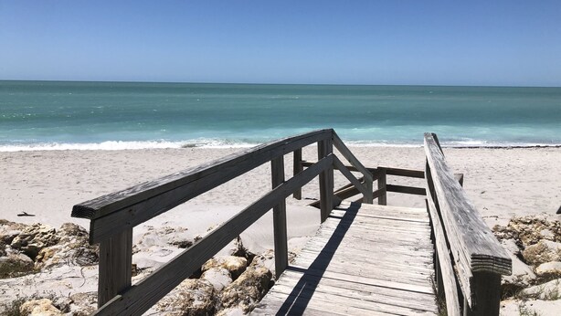 A wooden boardwalk leading to a beach with clear turquoise water and a clear sky. - "Pelican Nest"Private Beach & Bay access & Pool 4bedroom 3bath (Englewood)
