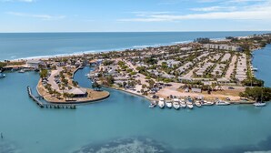 An aerial view of a coastal resort with a marina, beachfront, and residential areas. - "Pelican Nest"Private Beach & Bay access & Pool 4bedroom 3bath (Englewood)
