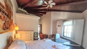 A bedroom with a bed, a dresser, a chair, a desk, and a ceiling fan. - Villa for rent in Club Patara holiday village (Kaş)