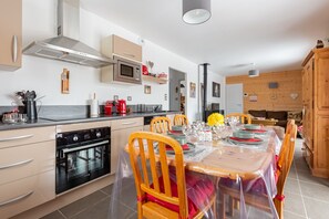 A modern kitchen with a dining area set for a meal.