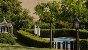 A landscaped garden with a pool, a gazebo, and neatly trimmed hedges. - Amazing villa with swimming pool into the nature with view over the Adriatic sea (Marche)