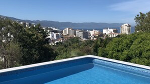 A swimming pool with a clear view of a cityscape and mountains in the background. - Gringo-Gulch, 3 bedroom w/view, pool/patio (Puerto Vallarta)