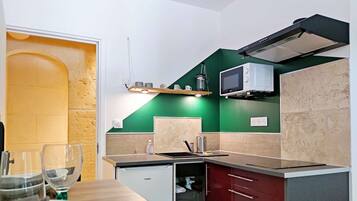 Fridge, microwave, coffee/tea maker, cookware/dishes/utensils