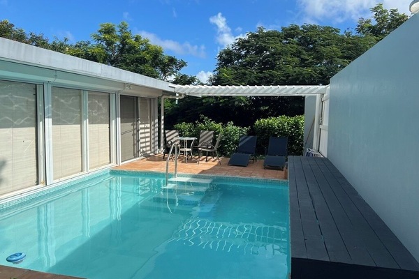 Beautiful remodeled pool with glass tile and graduated steps for easy access.