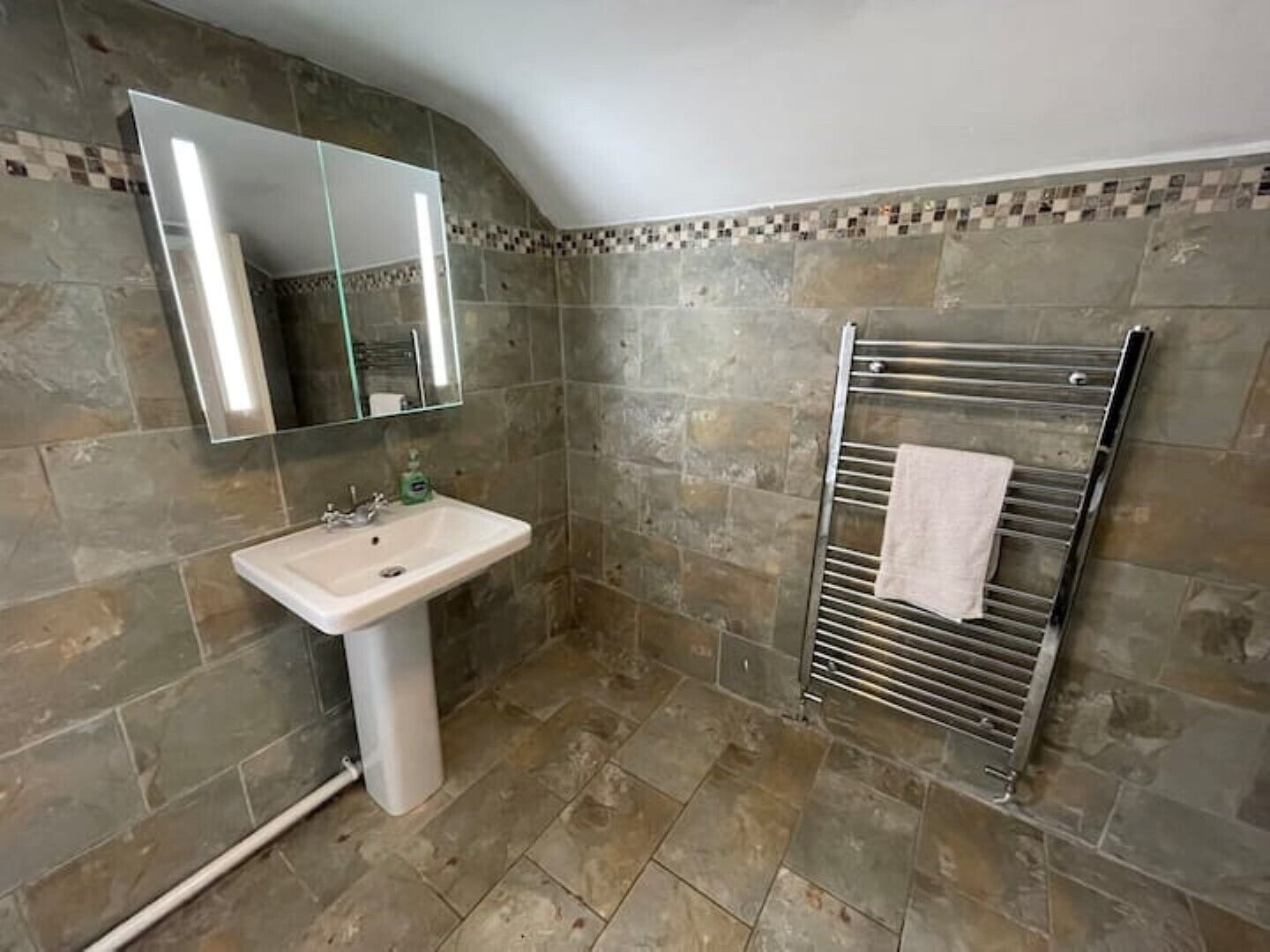 Bathtub, towels, soap, toilet paper