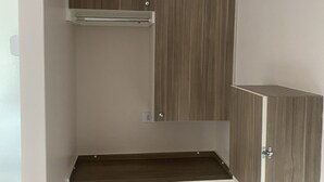 A small, enclosed room with a built-in cabinet, a shelf, and a door. - Hotel prime (São Paulo)