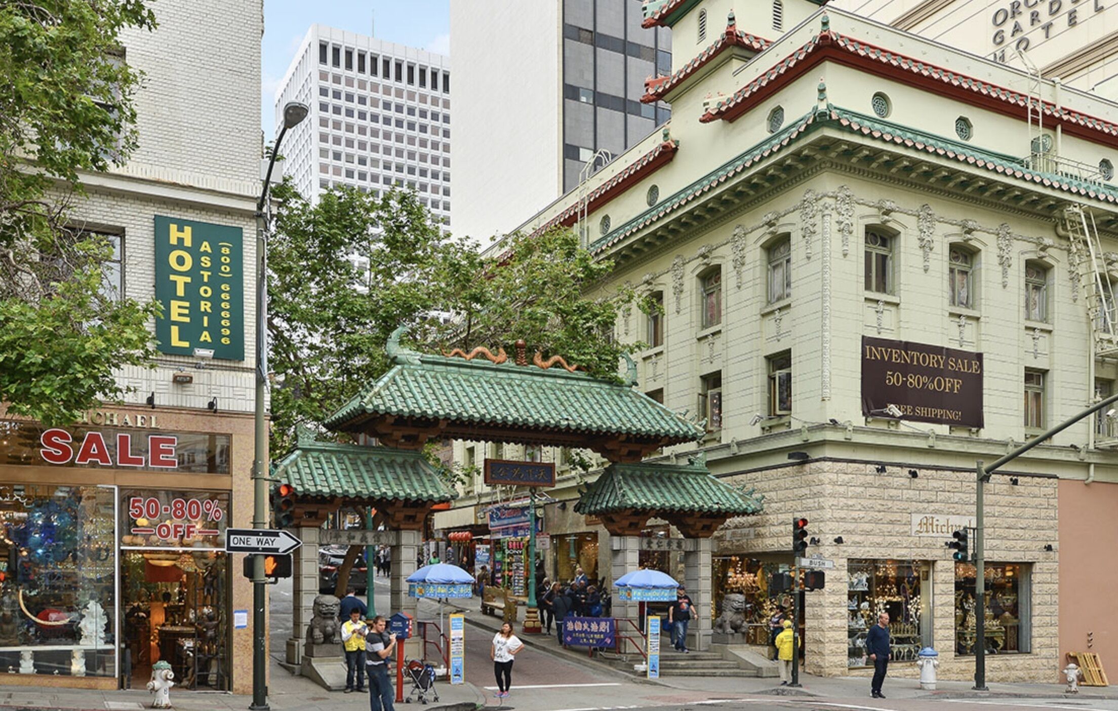 A historic building with a sign for an inventory sale offering 50-80% off.