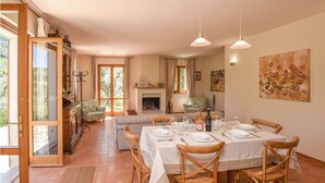 A dining area with a table set for four, surrounded by wooden chairs. - Lovely home in Toffia (Toffia)