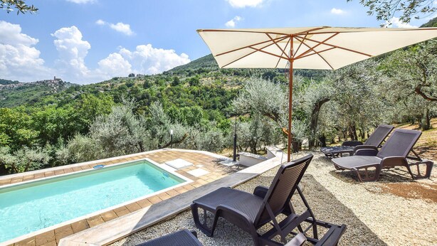 A poolside area with a pool, lounge chairs, and an umbrella. - Lovely home in Toffia (Toffia)