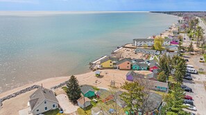 A coastal residential area with colorful houses, a sandy beach, and a clear view of the sea. - Aloha Beach Club Resort (Oscoda)