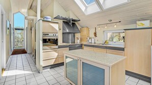 A modern kitchen with a built-in oven, a large stove, and a skylight. - Stunning home in Struer with WiFi (Struer)