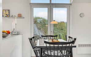 Enjoy a meal with a view of the surrounding countryside from this kitchen's dining table.