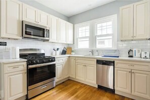 Enjoy cooking in this well-equipped kitchen with a gas stove, oven, and dishwasher.