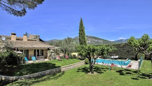 A house with a tiled roof, a swimming pool, and a stone wall. - Nice home in Condorcet (Condorcet)
