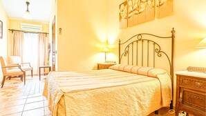 A bedroom with a bed, bedside tables, a chair, and a nightstand. - Nice home in Villafranca de Cordoba (Villafranca de Cordoba)