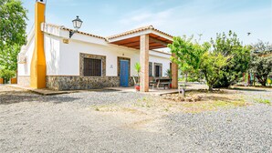 A two-story house with a stone foundation, a blue door, and a chimney. - Nice home in Villafranca de Cordoba (Villafranca de Cordoba)