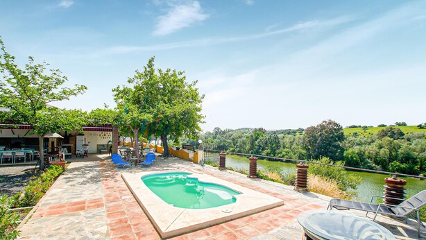 A swimming pool with a view of a river and hills, surrounded by outdoor seating and a covered area. - Nice home in Villafranca de Cordoba (Villafranca de Cordoba)