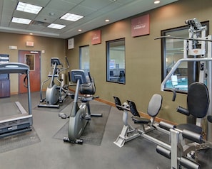 A gym with various exercise equipment, including treadmills, stationary bikes, and weight machines. - Comfort Suites Near Northeast Mall (Fort Worth)