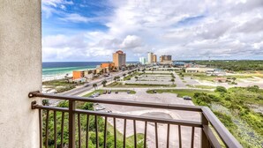 A cityscape with a beachfront view, including a prominent hotel and several high-rise buildings.